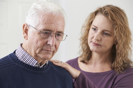 Senior man with adult daughter at home