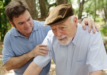 Senior man in failing health and his worried middle-aged son